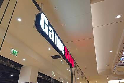 A Gamestop logo above a store. Photo: André Volkmann